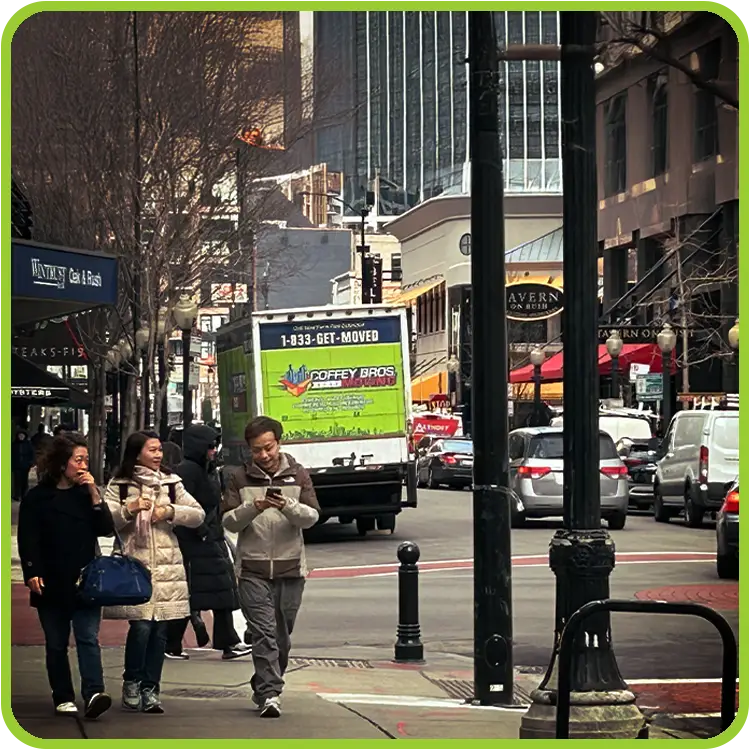 Coffey Bros Moving Truck driving down a city street